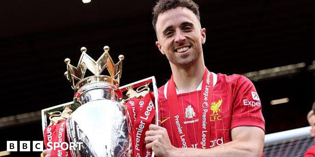 Diogo Jota holding the Premier League trophy while playing for Liverpool in May